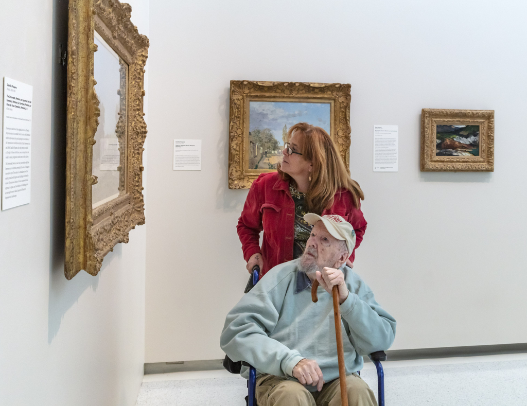 Two people looking at art.