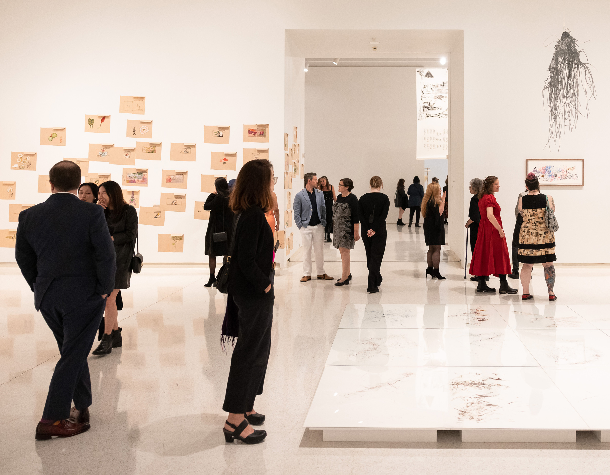 people in a gallery viewing Carnegie International 58 items