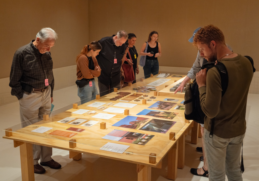 museum lookings looking at an exhibition on a table