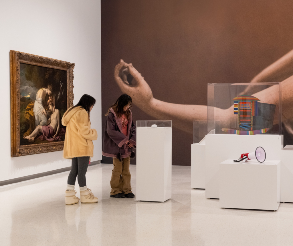 two museum visitors looking at object apart of Inheritance exhibition