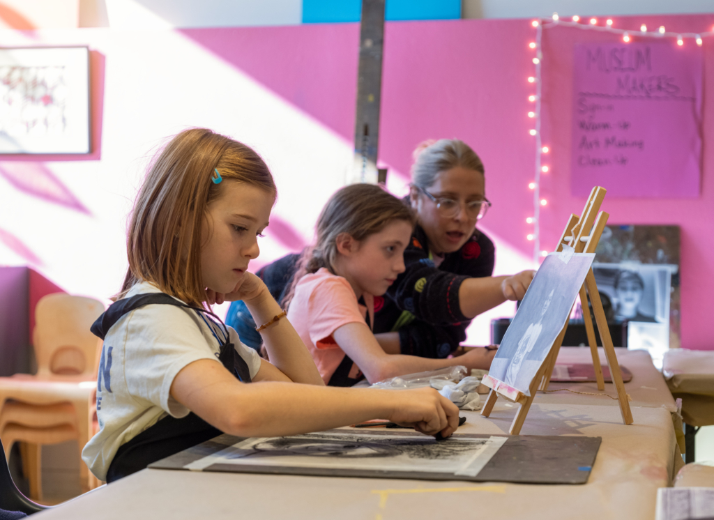 kids making art with charcoal