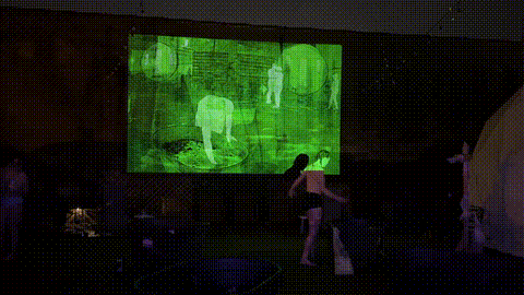 nica ross art work of someone sitting down in a bathtub while it is projected on a green screen