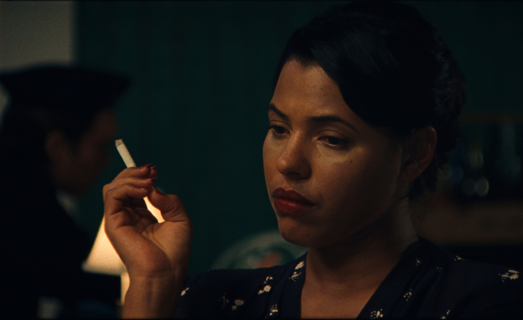 a film still of a woman smoking a cigarette