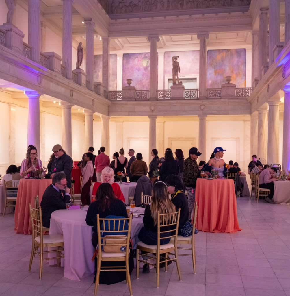 People in a pink-hued room