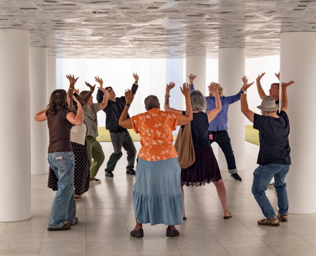 A photograph of people moving in a gallery