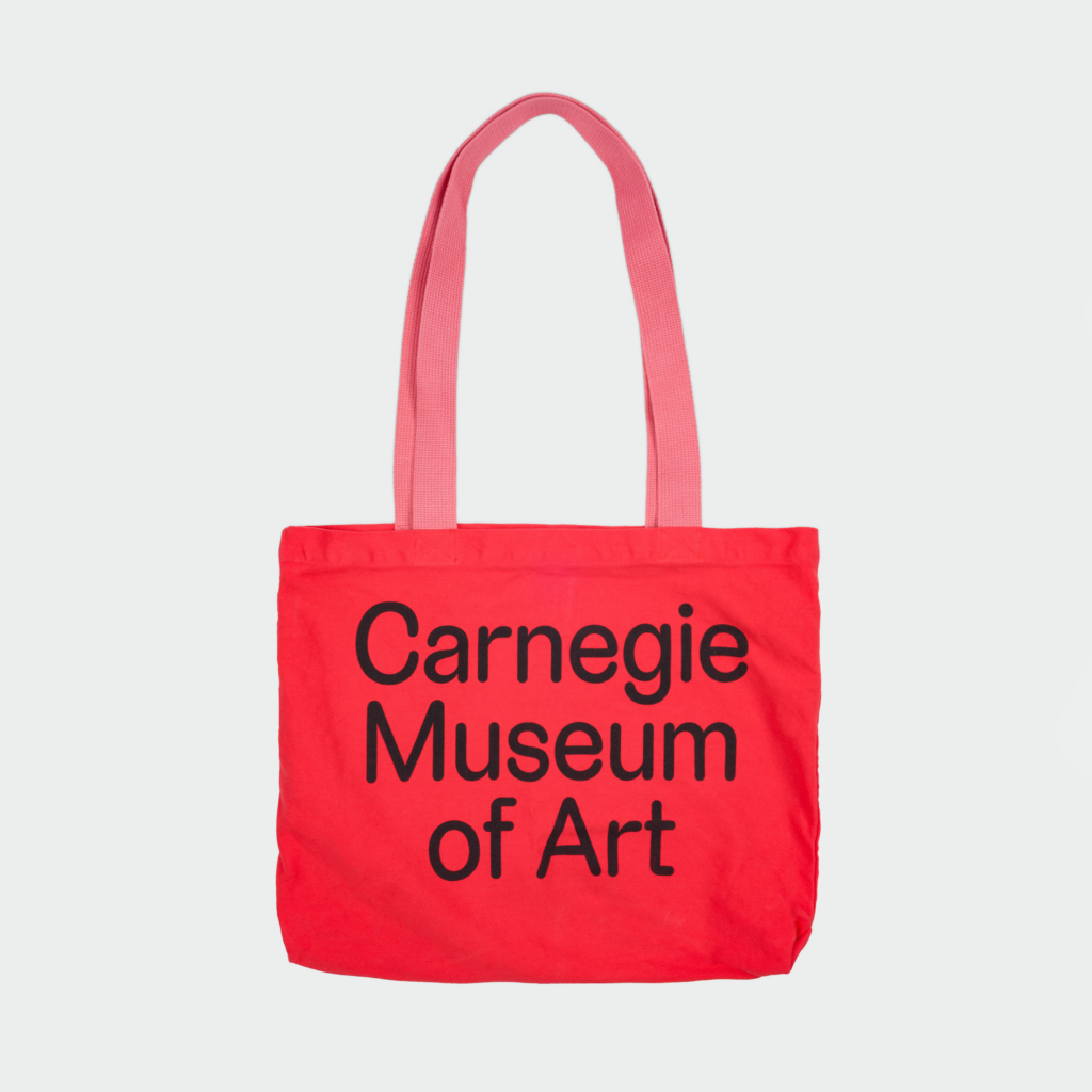 red tote bag that says carnegie museum of art